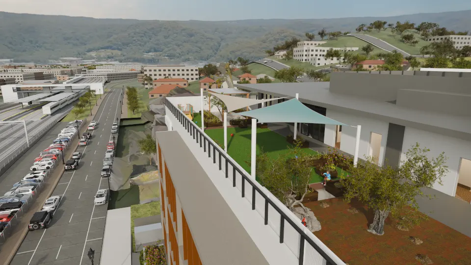 Elevated render looking along the Level 4 early learning rooftop: green turf under white shade sails, trees and planter boxes beside the glazed building, with the street and parked cars below