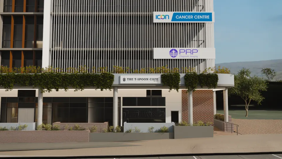 Street-level render of the Showground Road frontage: The T-Spoon Cafe sign on the podium fascia below cascading planting, with Icon Cancer Centre and PRP signs on the screened façade above